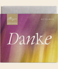 Thementafel Bio Vollmilch "Danke" – Tafelschokolade von Confiserie Berger, 70 g, freigestellt vor cremefarbenem Hintergrund