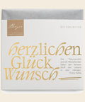 Thementafel Bio Edelbitter "Herzlichen Glückwunsch" – Tafelschokolade von Confiserie Berger, 70 g, freigestellt vor cremefarbenem Hintergrund