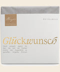 Thementafel Bio Vollmilch "Glückwunsch" – Tafelschokolade von Confiserie Berger, 70 g, freigestellt vor cremefarbenem Hintergrund