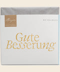 Thementafel Bio Vollmilch "Gute Besserung" – Tafelschokolade von Confiserie Berger, 70 g, freigestellt vor cremefarbenem Hintergrund