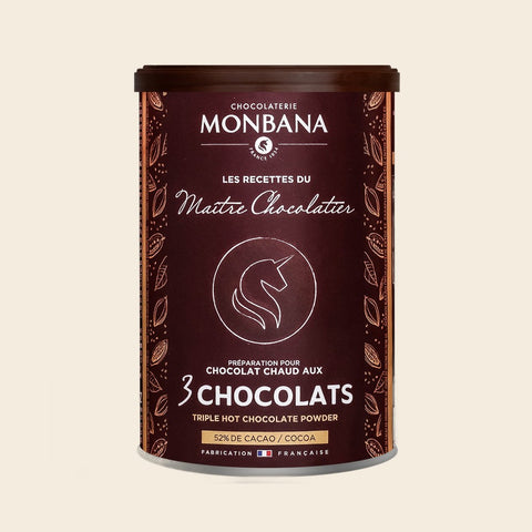 Monbana 3 Chocolats Trinkschokolade – 175 g Dose, freigestellt vor cremefarbenem Hintergrund