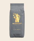 Hausbrandt Espresso H. Hausbrandt – Espresso, 1000 g, freigestellt vor cremefarbenem Hintergrund
